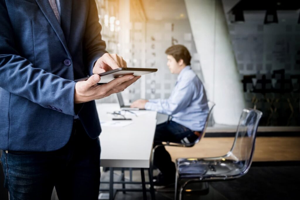 Businessman working with tablet in office, closeup