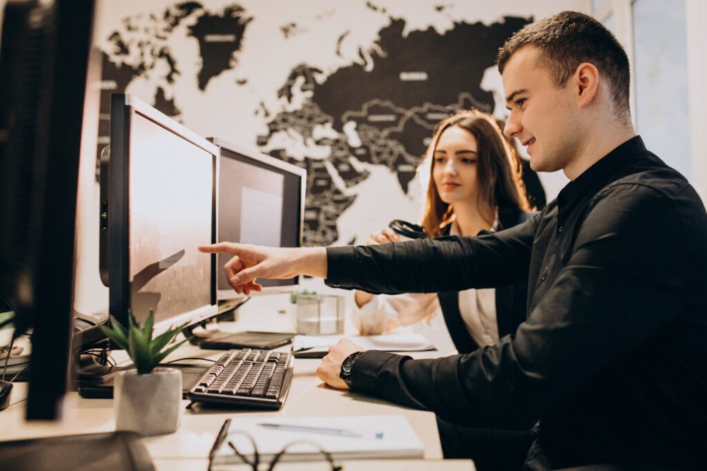 Man and woman working with computer in office